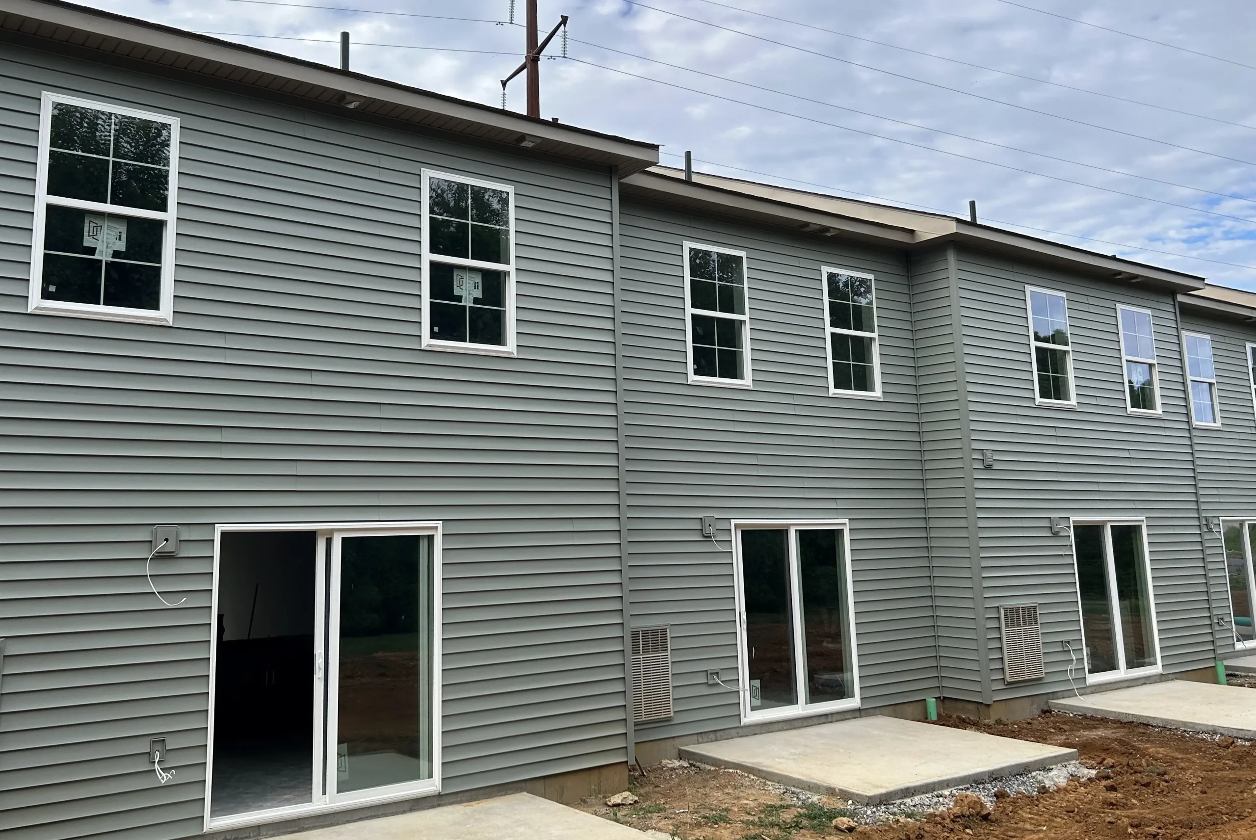 Expert siding contractor Bath PA installing gray vinyl siding, quality roofing and siding installation